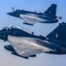 The image shows a Tejas Mk-1 trainer flying alonside a Tejas single-seat fighter