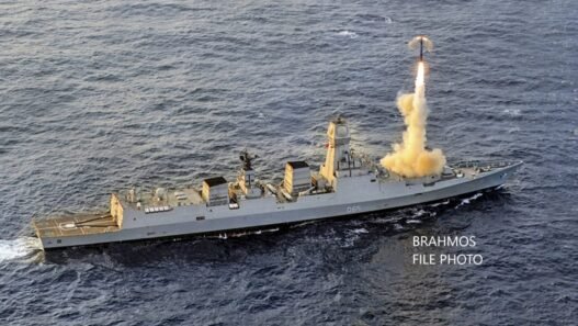 An Indian Navy warship is shown firing a BrahMos supersonic cruise missile.