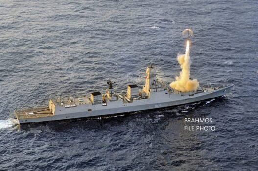 An Indian Navy warship is shown firing a BrahMos supersonic cruise missile.