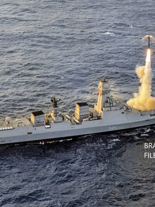 An Indian Navy warship is shown firing a BrahMos supersonic cruise missile.